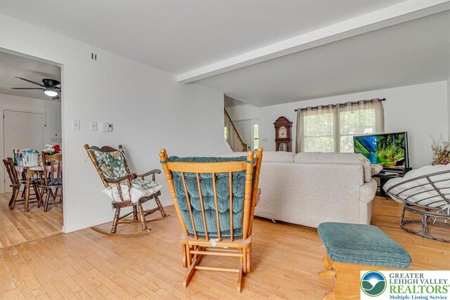 1281 Winding Way, Coolbaugh Twp, PA 18466 - living area with beam ceiling, ceiling fan, wood finished floors, and stairs