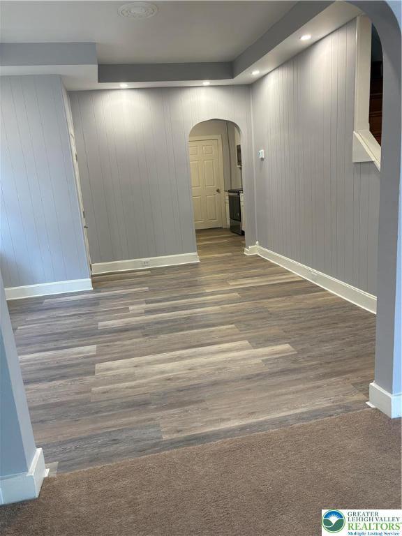 2101 Columbia Ave, Whitehall Twp, PA 18052 - spare room with arched walkways, baseboards, and wood finished floors