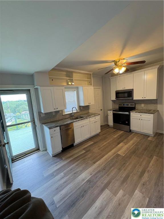 2101 Columbia Ave, Whitehall Twp, PA 18052 - kitchen with appliances with stainless steel finishes, a sink, white cabinets, and backsplash