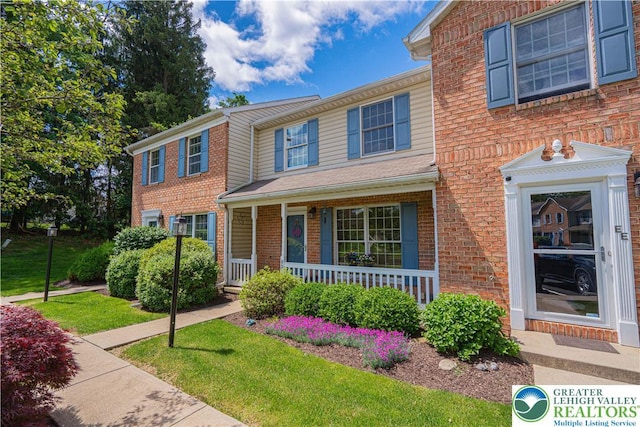 1514 Ravena St Unit Dd, Bethlehem City, PA 18015 - view of front facade featuring a porch and brick siding