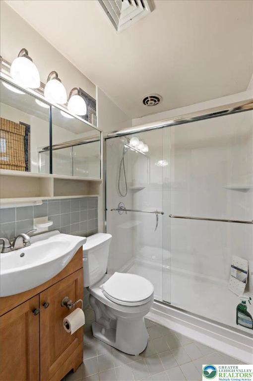 215 N Laurel Ln, West Whiteland Township, PA 19341 - bathroom featuring tile patterned floors, vanity, toilet, and a shower stall
