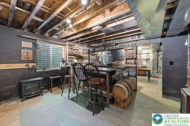 215 N Laurel Ln, West Whiteland Township, PA 19341 - indoor dry bar with concrete floors and a wood stove