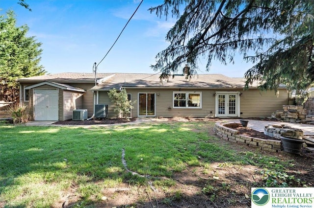 215 N Laurel Ln, West Whiteland Township, PA 19341 - back of property with french doors, central AC, a yard, and an attached garage