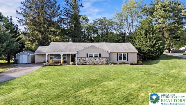 215 N Laurel Ln, West Whiteland Township, PA 19341 - ranch-style home featuring asphalt driveway, a front lawn, covered porch, an outdoor structure, and a chimney