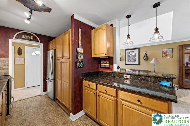 215 N Laurel Ln, West Whiteland Township, PA 19341 - kitchen featuring appliances with stainless steel finishes, a peninsula, dark stone countertops, decorative light fixtures, and baseboards