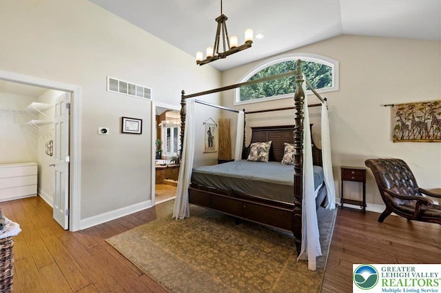 215 N Laurel Ln, West Whiteland Township, PA 19341 - bedroom with vaulted ceiling, a chandelier, wood finished floors, baseboards, and arched walkways
