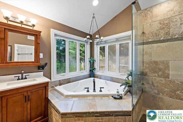 215 N Laurel Ln, West Whiteland Township, PA 19341 - bathroom with lofted ceiling, vanity, a garden tub, and a chandelier