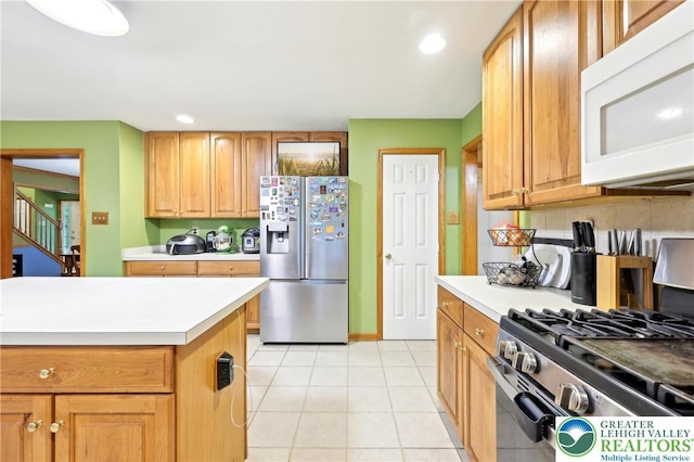 136 Outlook Ct, Middle Smithfield Twp, PA 18302 - kitchen featuring stainless steel appliances, light countertops, light tile patterned floors, recessed lighting, and tasteful backsplash