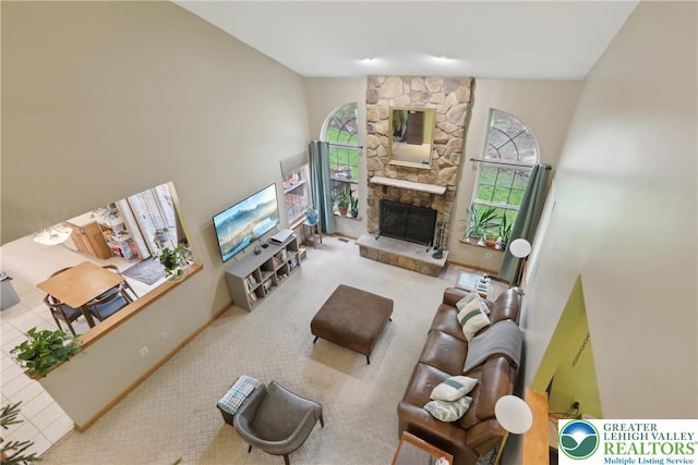 136 Outlook Ct, Middle Smithfield Twp, PA 18302 - carpeted living area featuring a stone fireplace and a towering ceiling