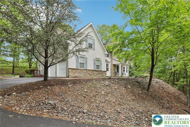 136 Outlook Ct, Middle Smithfield Twp, PA 18302 - view of front of home with driveway, a garage, and stone siding