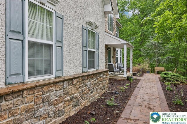 136 Outlook Ct, Middle Smithfield Twp, PA 18302 - view of side of home with a porch and stone siding