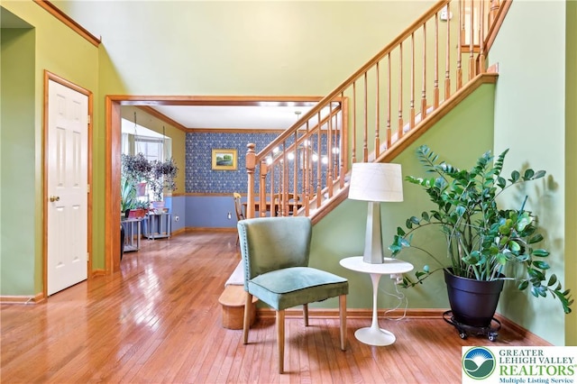 136 Outlook Ct, Middle Smithfield Twp, PA 18302 - living area featuring wallpapered walls, baseboards, wood-type flooring, stairs, and ornamental molding