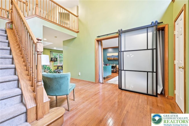 136 Outlook Ct, Middle Smithfield Twp, PA 18302 - kitchen with a barn door, hardwood / wood-style flooring, a high ceiling, and baseboards