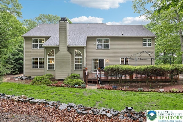136 Outlook Ct, Middle Smithfield Twp, PA 18302 - rear view of house featuring a deck, a chimney, and a lawn