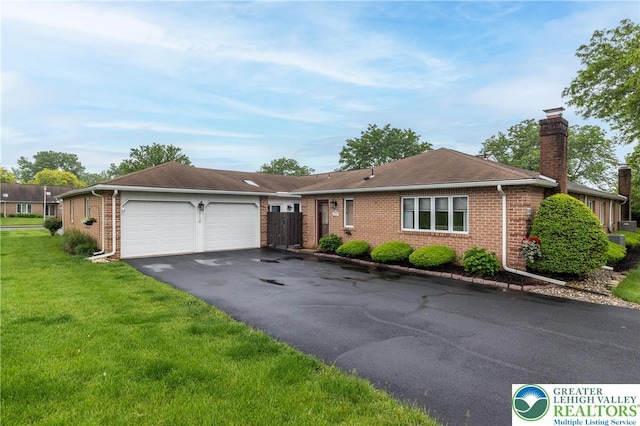 5752 Tavistock Ln, Lower Macungie Twp, PA 18062 - single story home with brick siding, a chimney, a front lawn, and asphalt driveway
