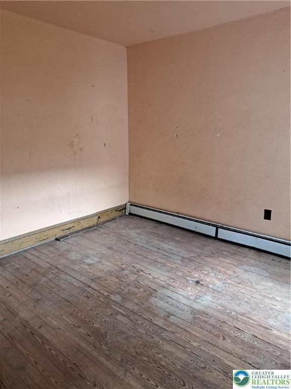 466 Franklin Ave, Palmerton Borough, PA 18071 - empty room with hardwood / wood-style floors and a baseboard heating unit