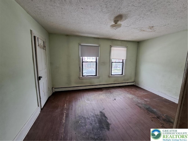 466 Franklin Ave, Palmerton Borough, PA 18071 - spare room featuring baseboard heating, hardwood / wood-style floors, a textured ceiling, and baseboards