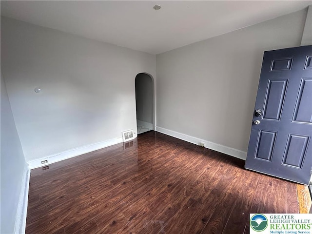 432 Schaffers Ct, Easton, PA 18042 - empty room featuring dark wood finished floors, arched walkways, and baseboards