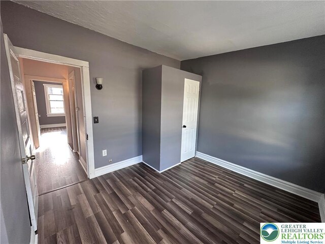 432 Schaffers Ct, Easton, PA 18042 - unfurnished bedroom featuring baseboards and dark wood-type flooring