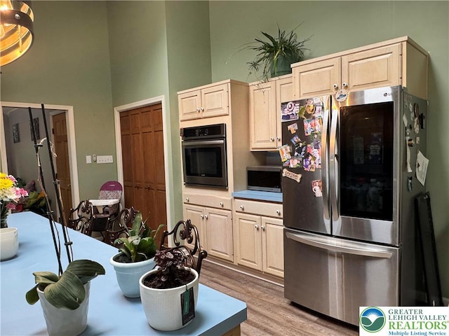 462 Plane St, Weatherly Boro, PA 18255 - kitchen with appliances with stainless steel finishes, light wood-type flooring, a towering ceiling, and light brown cabinets