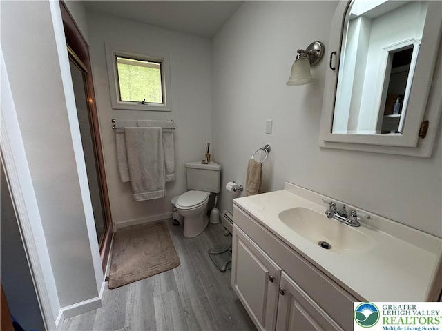462 Plane St, Weatherly Boro, PA 18255 - full bath with wood finished floors, vanity, toilet, a stall shower, and a baseboard heating unit