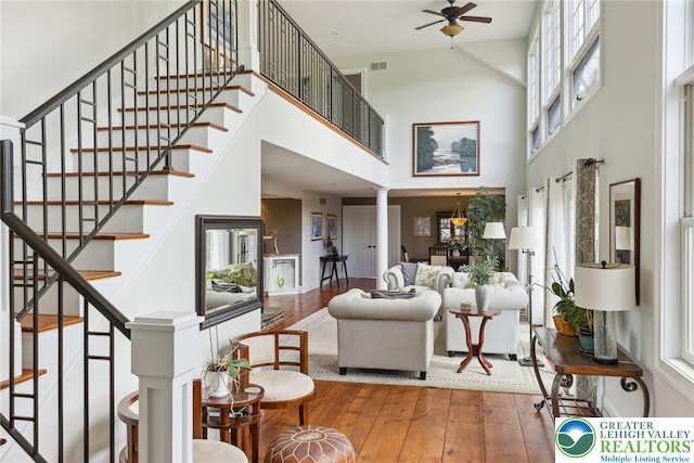 2965 Adams Way, Springfield Twp, PA 18077 - living room with hardwood / wood-style flooring, a high ceiling, ceiling fan, ornate columns, and stairway