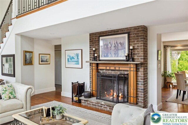 2965 Adams Way, Springfield Twp, PA 18077 - living room with hardwood / wood-style floors, a brick fireplace, baseboards, and stairway
