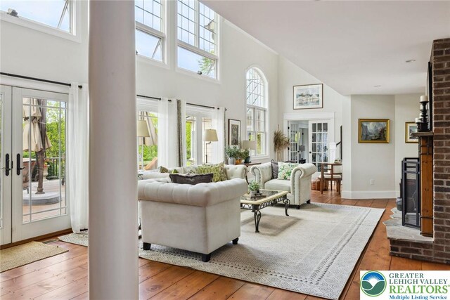 2965 Adams Way, Springfield Twp, PA 18077 - living room featuring french doors, a high ceiling, plenty of natural light, wood-type flooring, and baseboards