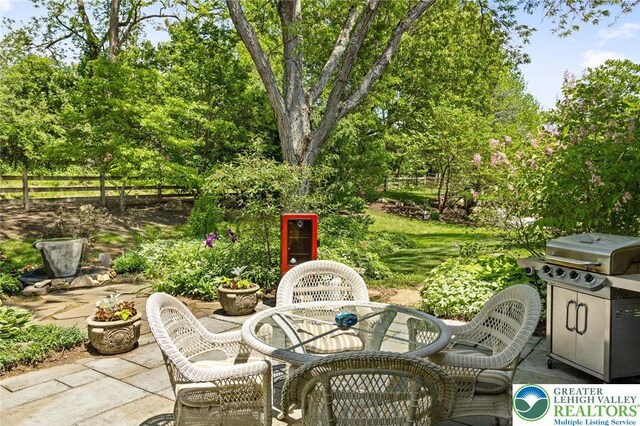 2965 Adams Way, Springfield Twp, PA 18077 - view of patio / terrace featuring outdoor dining space, a grill, and view of wooded area