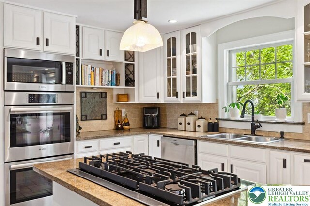 2965 Adams Way, Springfield Twp, PA 18077 - kitchen featuring appliances with stainless steel finishes, a sink, white cabinets, and tasteful backsplash