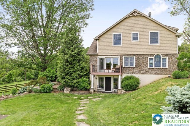2965 Adams Way, Springfield Twp, PA 18077 - back of house featuring stone siding and a balcony