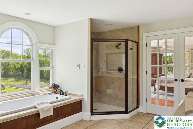 2965 Adams Way, Springfield Twp, PA 18077 - bathroom featuring french doors, a bath, a stall shower, tile patterned flooring, and ensuite bathroom
