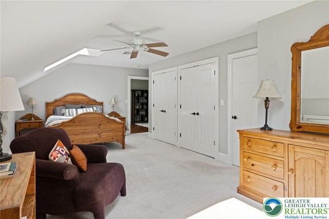 2965 Adams Way, Springfield Twp, PA 18077 - bedroom with light colored carpet, two closets, lofted ceiling, ceiling fan, and a skylight