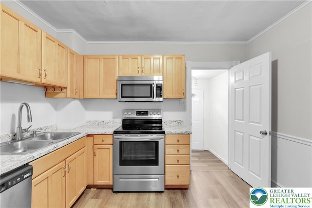 1123 Spruce St, Easton, PA 18042 - kitchen featuring appliances with stainless steel finishes, light brown cabinetry, a sink, light wood finished floors, and ornamental molding