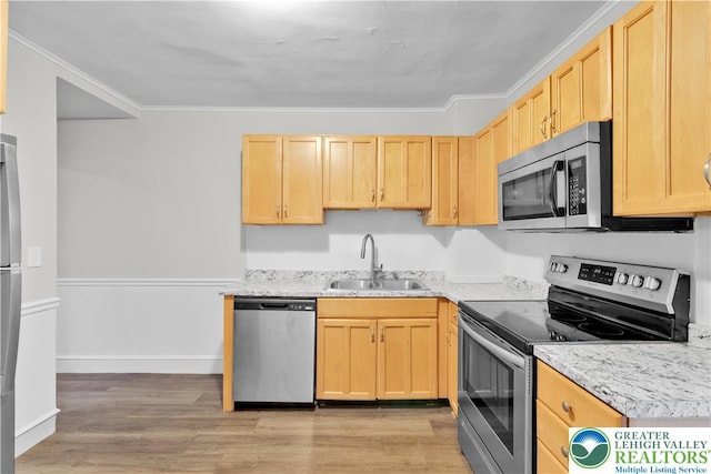 1123 Spruce St, Easton, PA 18042 - kitchen with appliances with stainless steel finishes, a sink, light brown cabinets, light wood-style floors, and ornamental molding