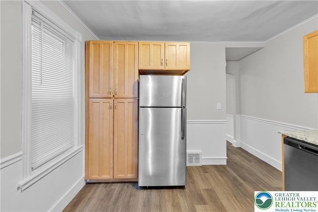 1123 Spruce St, Easton, PA 18042 - kitchen with stainless steel appliances, wood finished floors, light brown cabinets, ornamental molding, and baseboards