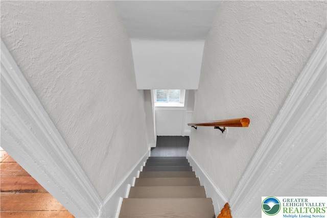 1123 Spruce St, Easton, PA 18042 - staircase featuring a textured wall, wood finished floors, and baseboards