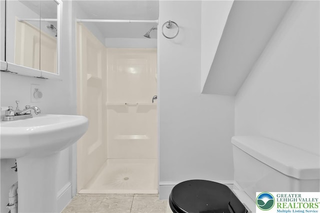1123 Spruce St, Easton, PA 18042 - bathroom with toilet, a shower stall, baseboards, and a sink