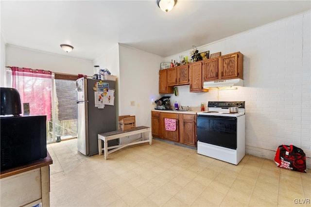 1208 Union St, Allentown City, PA 18102 - kitchen featuring freestanding refrigerator, electric stove, under cabinet range hood, brown cabinets, and black microwave