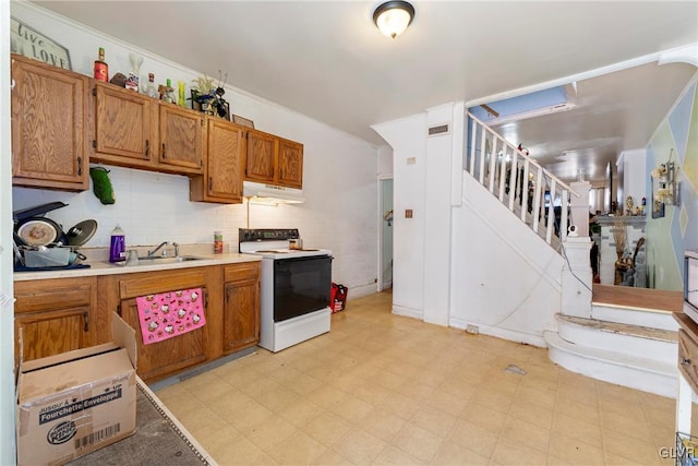 1208 Union St, Allentown City, PA 18102 - kitchen featuring white range with electric stovetop, a sink, ventilation hood, brown cabinets, and light floors