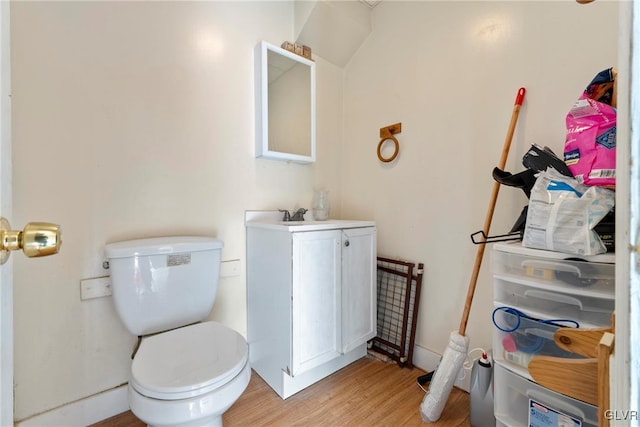 1208 Union St, Allentown City, PA 18102 - half bathroom with toilet, wood finished floors, and vanity
