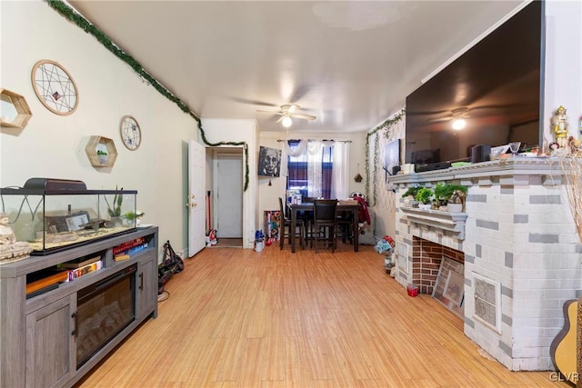 1208 Union St, Allentown City, PA 18102 - living room with light wood finished floors, a fireplace, and a ceiling fan