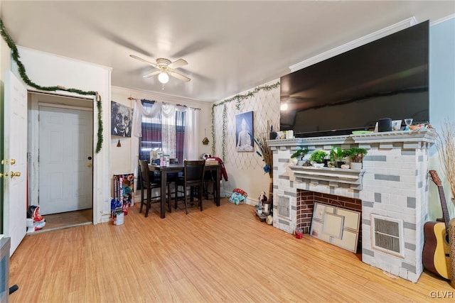 1208 Union St, Allentown City, PA 18102 - living room with a ceiling fan, wood finished floors, a fireplace, baseboards, and crown molding
