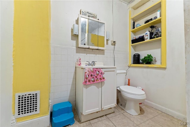 1208 Union St, Allentown City, PA 18102 - half bath with tile walls, toilet, tile patterned flooring, vanity, and wainscoting