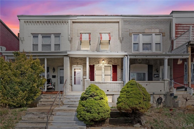 521 S Bradford St, Allentown City, PA 18109 - townhome / multi-family property with brick siding, a porch, and stairway