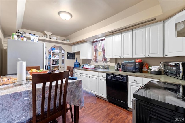 521 S Bradford St, Allentown City, PA 18109 - kitchen featuring black appliances, white cabinetry, dark wood-type flooring, light countertops, and a sink