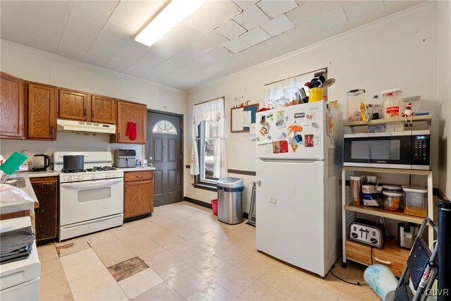 526 N Law St, Allentown City, PA 18102 - kitchen featuring white appliances, under cabinet range hood, brown cabinets, and light countertops