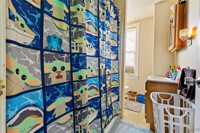 117 S 15th St, Wilson Borough, PA 18042 - bathroom with a paneled ceiling, toilet, vanity, tile patterned floors, and a shower with shower curtain