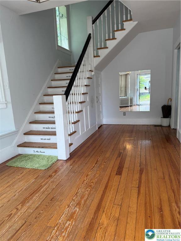 204 Analomink St, East Stroudsburg, PA 18301 - stairway featuring hardwood / wood-style floors, healthy amount of natural light, cooling unit, and baseboards