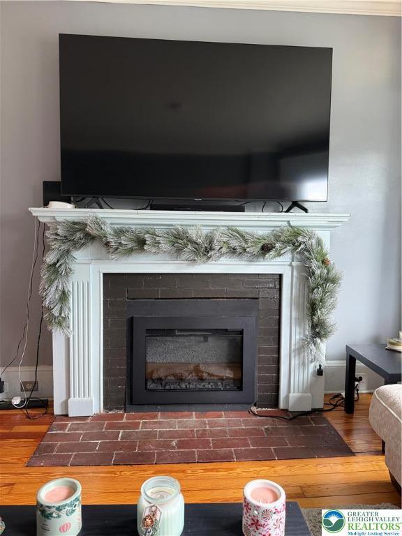 204 Analomink St, East Stroudsburg, PA 18301 - detailed view of a brick fireplace, wood finished floors, and baseboards